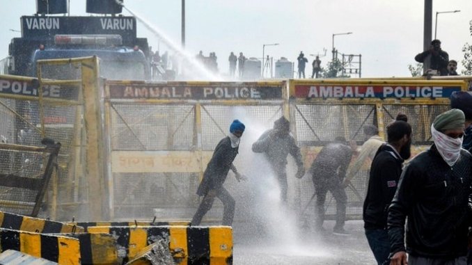 Security personnel utilize tear gas during 'Delhi Chalo' march