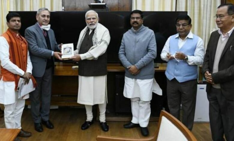 Shri Dharmendra Pradhan presents a book titled India: The Mother of Democracy to the Prime Minister Shri Narendra Modi
